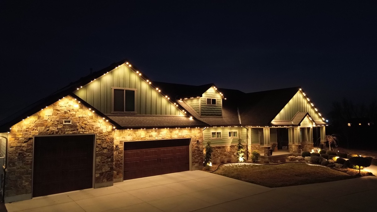 Salt Lake City home with TruLight permanent LED lighting showing warm white roofline across the exterior