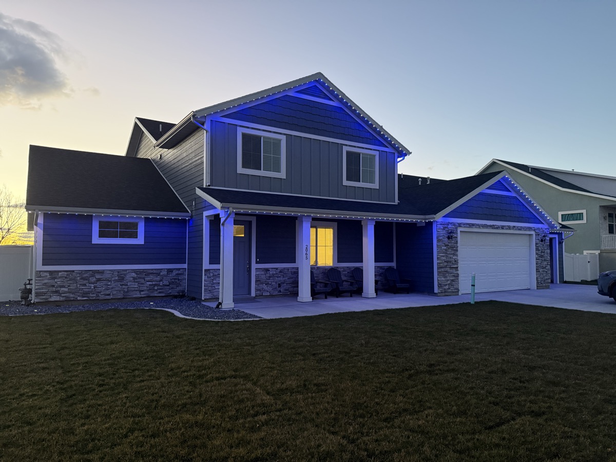 Salt Lake City home exterior with permanent LED lighting showing warm white accent glow